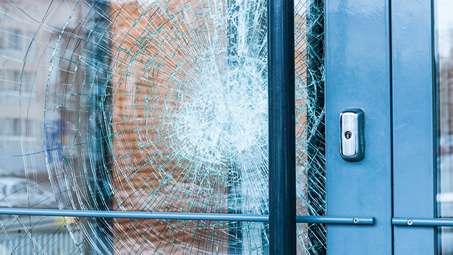 Eine kaputte Fenstertür mit Verbundsicherheitsglas, bei dem der die Glascherben an der Folie haften