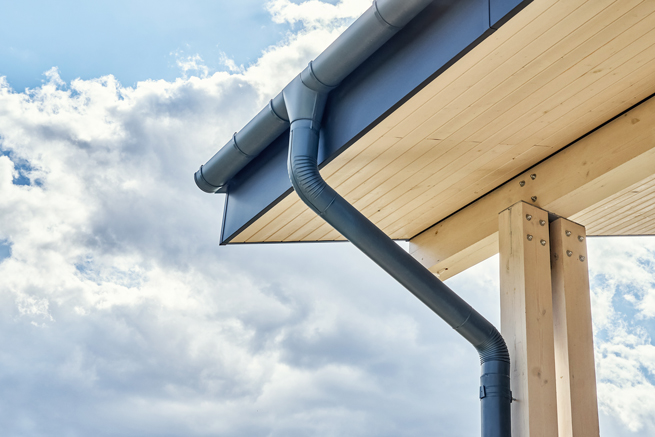 Terrassendachecke aus Holz und Aluminium mit Entwässerungsrinne und Rohr