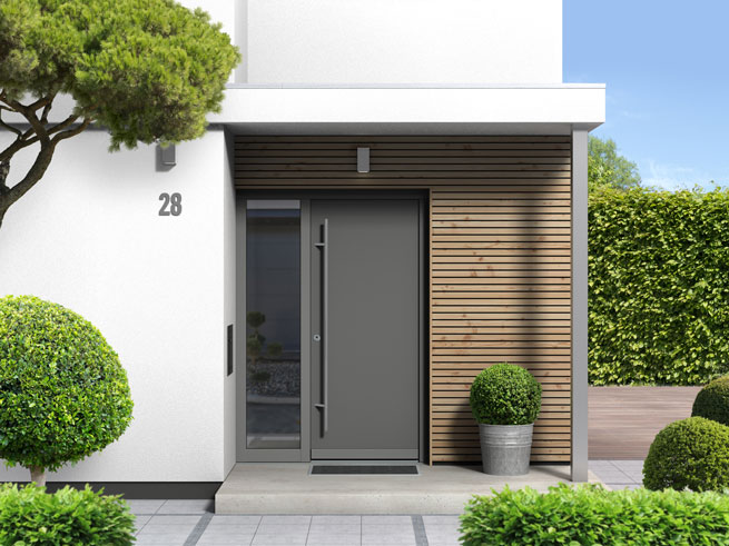 Porte d’entrée anthracite sur mur en bois