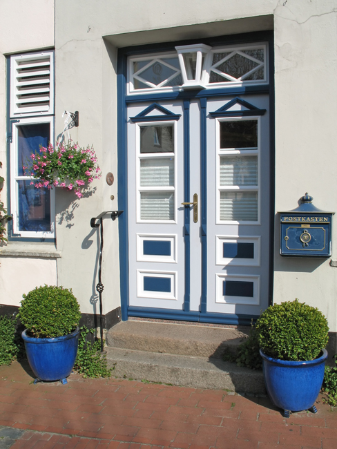 Weiß-blau gestrichene zweiflügelige Haustür mit Oberlicht im Landhausstil